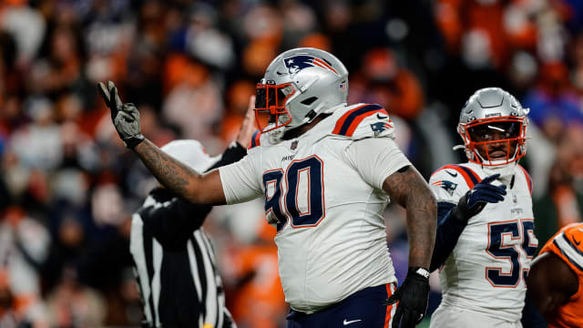 New England Patriots defensive tackle Christian Barmore (90) reacts after a play ]in the third quarter against the Denver Broncos at Empower Field at Mile High.